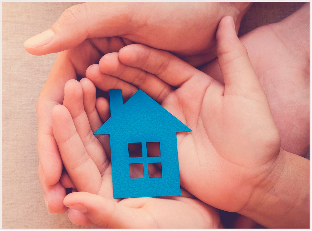 Hands holding a paper house